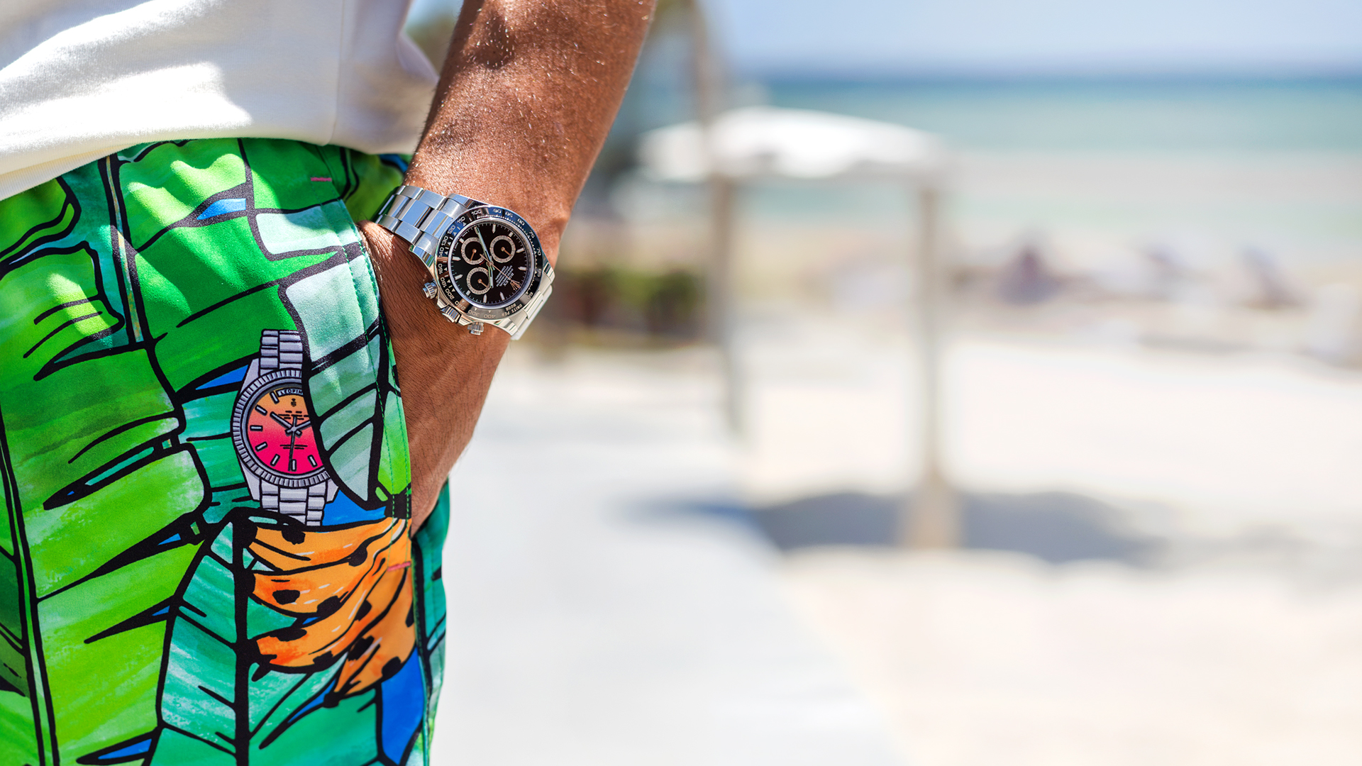 A collector on the beach in Leopine Palm o'Clock swim shorts, a chronograph on the wrist