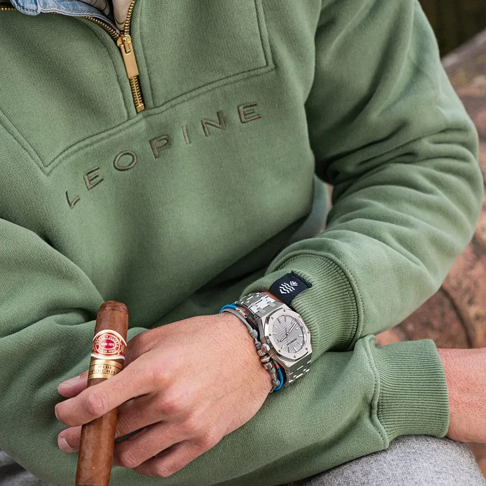The sage quarter-zip, a cigar and a steel sports watch